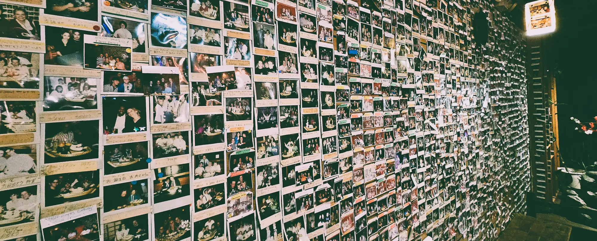 Wall of polaroid pictures of happy customers