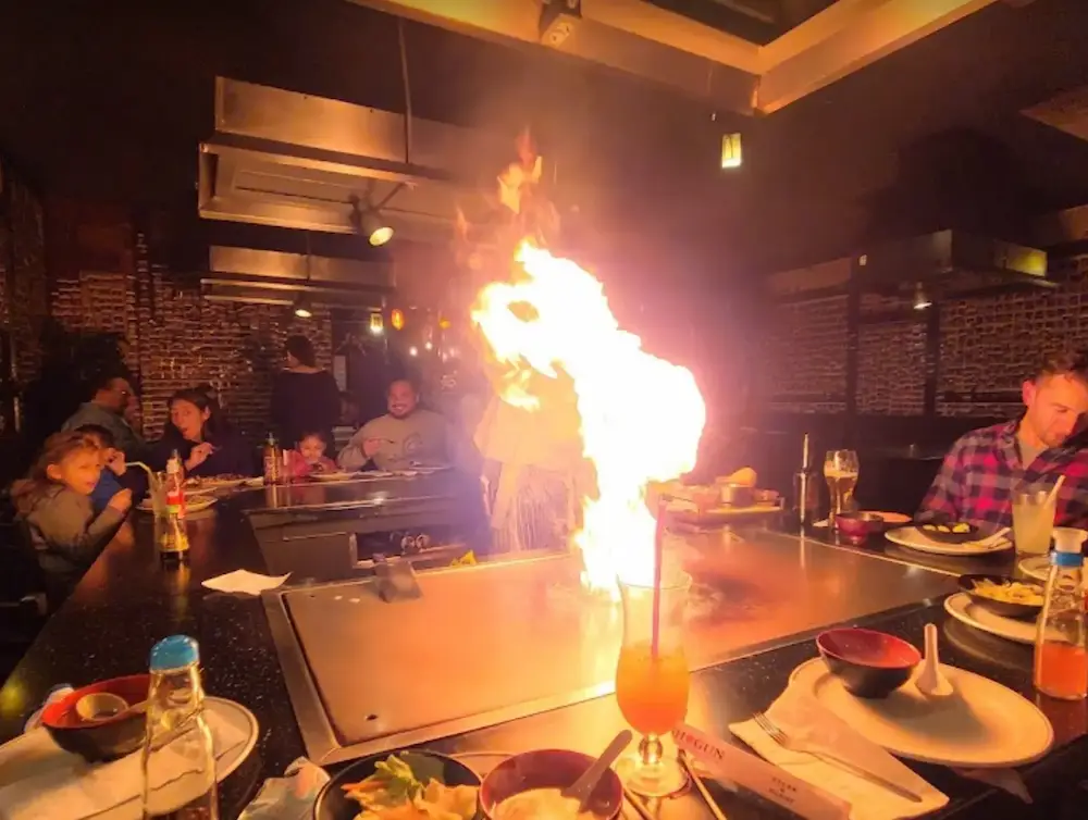 Hibachi chef cooking with high flames