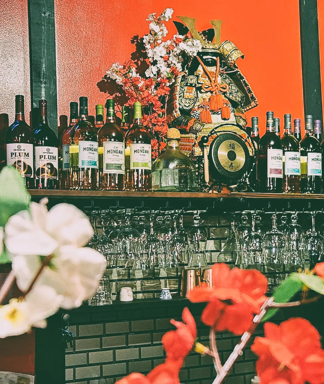 Bar area of the restaurant with a japanese samarui and sakura flowers