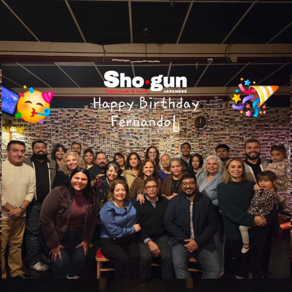 A large group of people celebrating a birthday at Shogun Japanese Steakhouse.