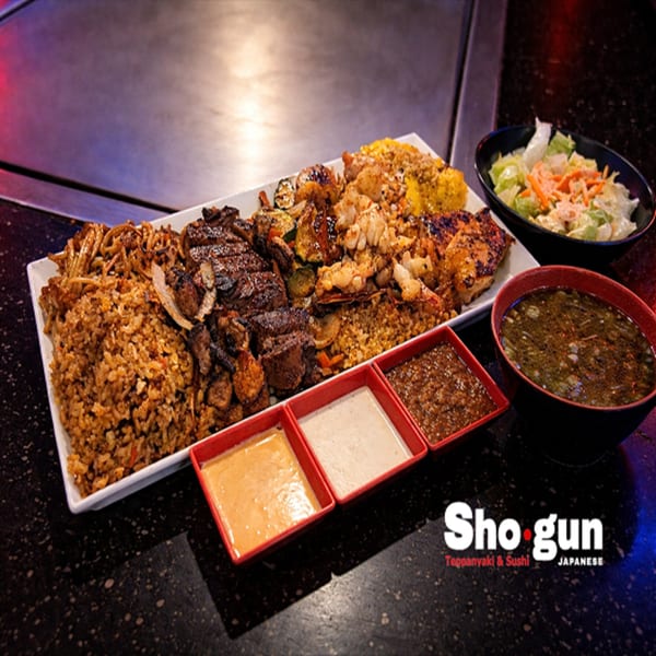 Shogun Teppanyaki & Sushi Japanese restaurant's large platter of fried rice, steak, chicken, shrimp, and vegetables with dipping sauces, soup, and salad.